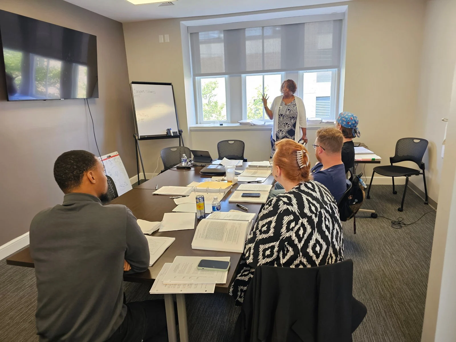 Photo of a man in a lab coat examining a bottle with a white version of the Unilever logo superimposed in the middle foreground